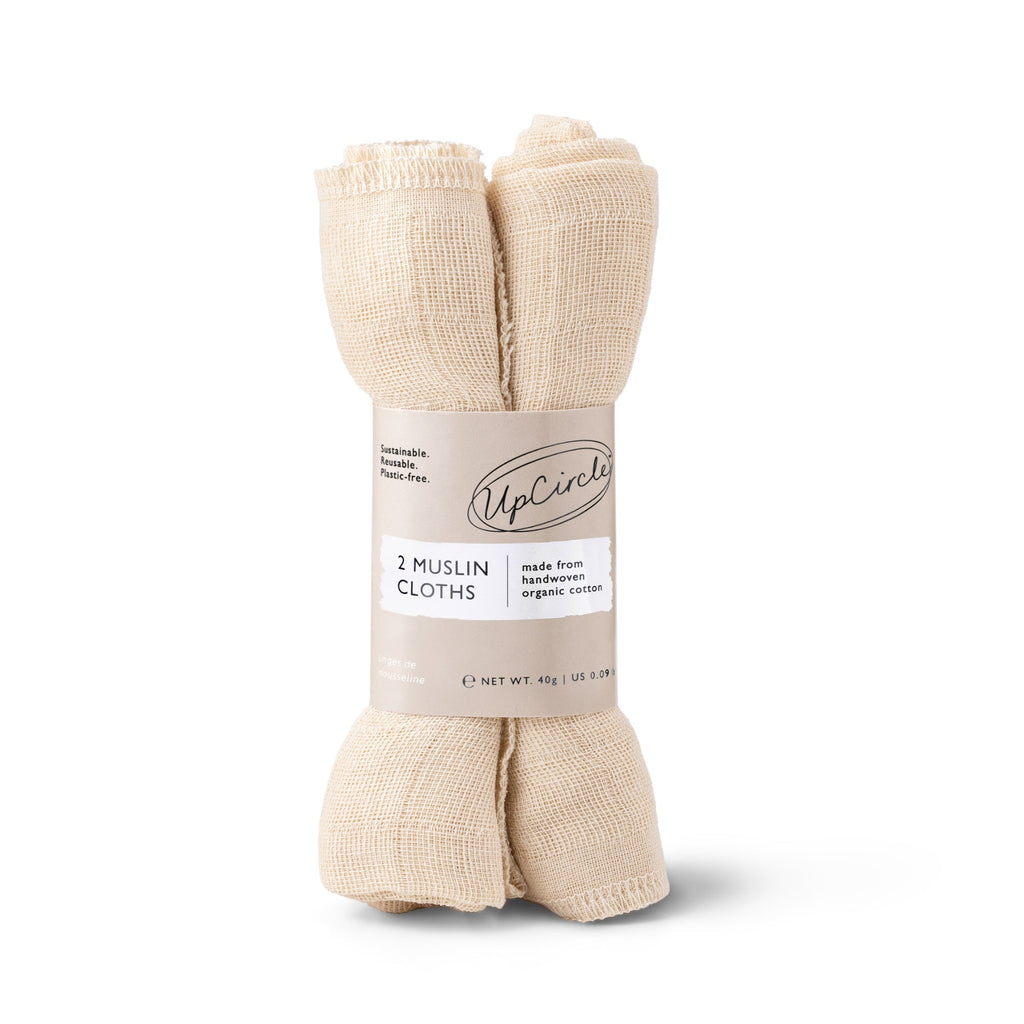 Two rolled beige muslin face cloths bundled together with a paper label.