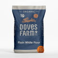 A 25 kg bag of Doves Farm Organic Plain White Flour, featuring a navy blue and gray packaging design with white text and a small orange 25 KG badge.