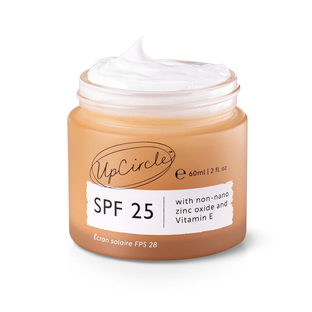 Jar of sunscreen cream with SPF 25 label on a white background