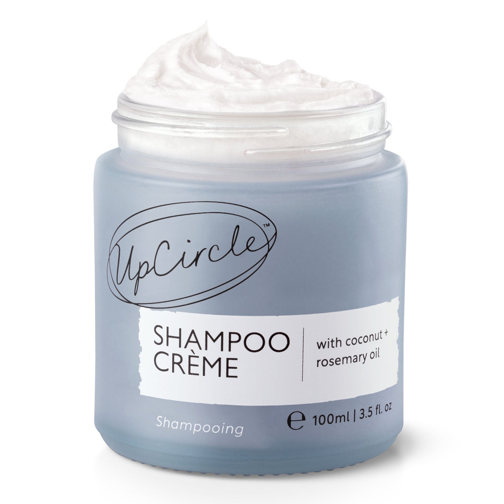 Jar of UpCircle Shampoo Crème with a white lid on a white background