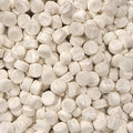 A close-up pile of round, off-white tablets or pills filling the frame.