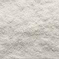 This close-up photograph showcases an abstract view of white powder, featuring a textured surface, filling the entire frame.