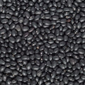 A close-up, top-down view of a dense pile of black beans filling the entire frame.