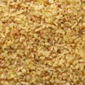 This close-up, top-down shot showcases the varied textures and shapes of bulgur wheat. 