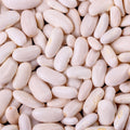 A close-up, top-down view of numerous pale beige beans filling the entire frame.