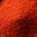 A close up shot filled with bright red chili powder.