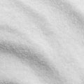 A close-up texture shot of white citric acid, filling the entire frame. 