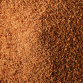 A bowl filled with fine brown coconut powder, filling the entire frame. 
