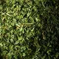 Dried green coriander flakes filling the entire frame.  