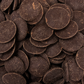 A close-up pile of dark chocolate buttons filling the frame