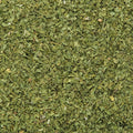 A textured, detailed close-up showcases bright green dried parsley flakes. 
