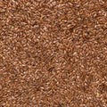 A close-up, top-down view of a dense pile of brown flaxseeds filling the entire frame.