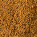 A close-up textured shot of garam masala filling the entire frame. 