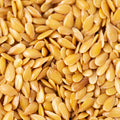 This close-up photo showcases a large quantity of golden flax seeds.