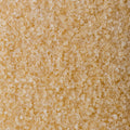 A close up shot of golden granulated sugar, filling the entire frame. 