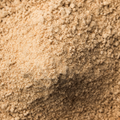 Ground ginger powder filling the entire frame. 