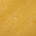 A close-up abstract image features a textured yellow surface. The even lighting and tight framing create a seamless, organic backdrop. 