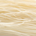 This extreme close-up captures the intricate and repetitive texture of dry, flat rice noodles.