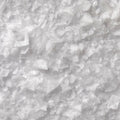 A close-up texture shot of coarse, translucent white salt crystals filling the entire frame.