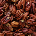An enticing close-up captures a mound of rich brown pecan halves.