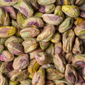 This enticing close-up showcases a vibrant cluster of de-shelled pistachios, revealing the unique colors and textures of the nuts.