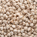 A close-up, top-down view of a dense pile of puffed buckwheat with light brown speckles and textured outer skins.