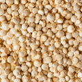 This photograph shows a close up of raw quinoa seeds. 