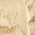 A textured macro close up of organic semolina flour filling the entire frame. 
