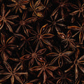 A close-up shot features star anise pods arranged on a dark surface, filling the entire frame. 