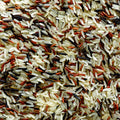 This high-angle close-up captures the intricate texture of a mixture of uncooked wild rice. 
