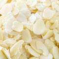 This bright, close-up shot features sliced almonds filling the entire frame. 