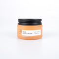 Jar of face moisturizer with a black lid on a white background