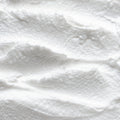 A close-up texture shot of a thick, creamy UpCircle Shampoo Creme with swirled ridges.