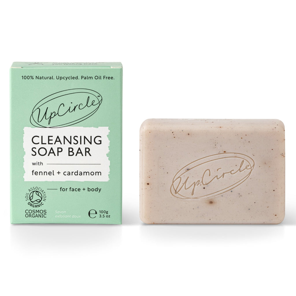UpCircle Cleansing Soap Bar with fennel and cardamom beside its mint green product box on a white background