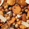 This extreme close-up shot shows a colorful and diverse assortment of Japanese rice crackers. 